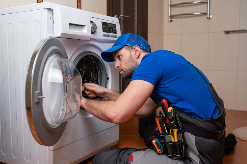 a technician repairing a washer and dryer repair roswell