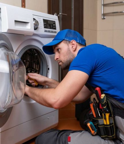 a technician repairing a washer and dryer repair roswell